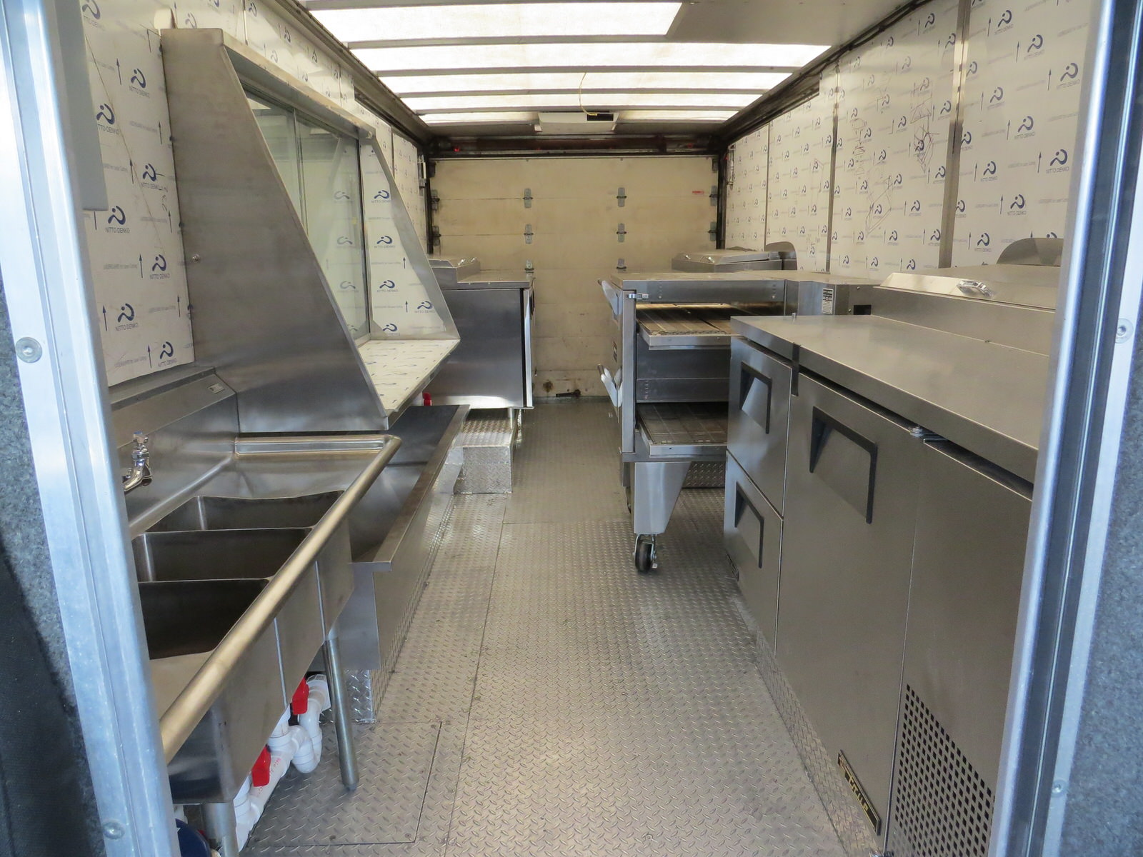 The Brozinni Pizzeria food truck's interior features custom aluminum diamond tread floor plating and much more.