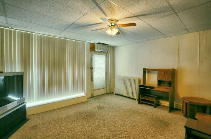 The property was a residence for a brief time between Penny's Flowers and our purchase. This was a living area on the first floor in the old storefront which was removed for our studio.