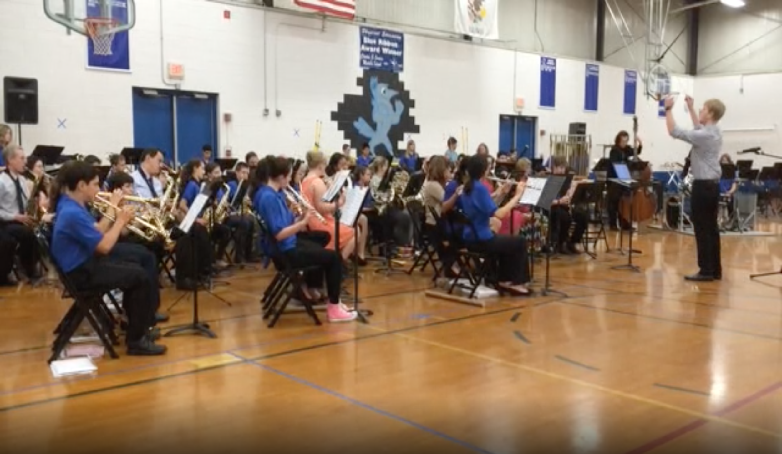 Geoff Shell composes and conducts "The Road Warrior" for retiring Caruso Jr. High School band director