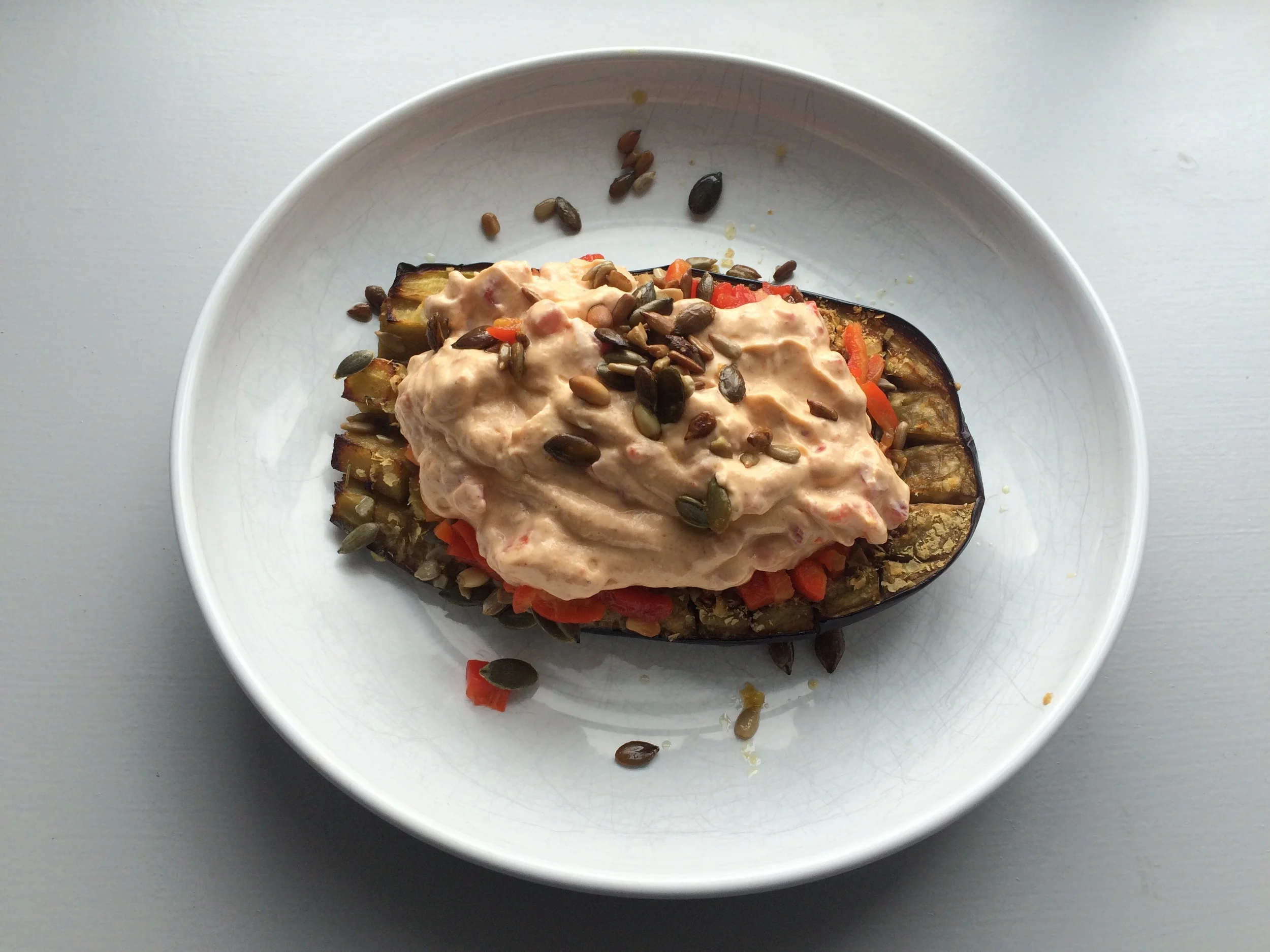 Roasted aubergine (w) spicy red pepper yoghurt topping.
