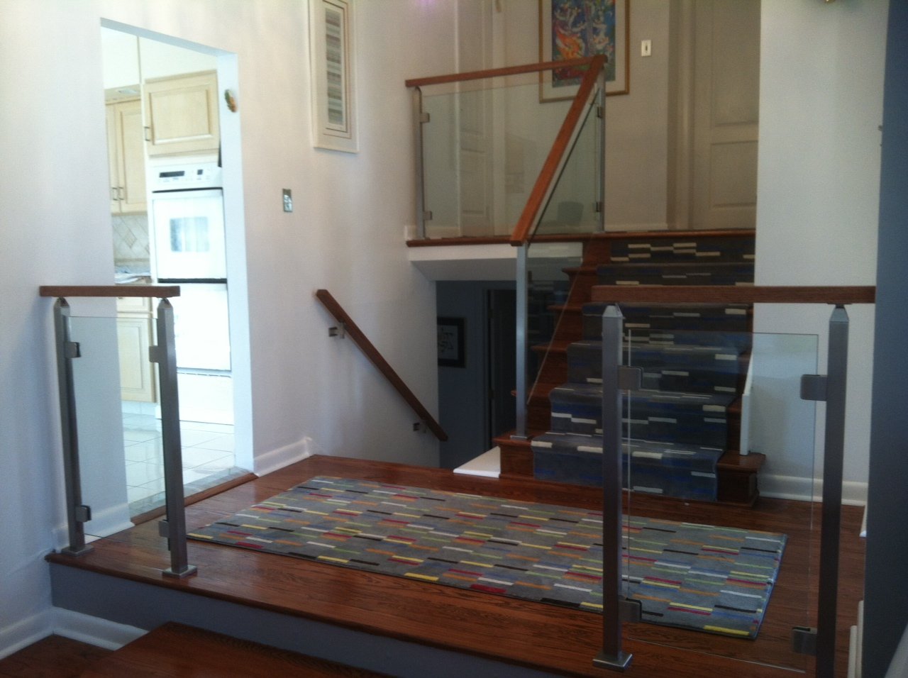 glass railing with clips and wood top handrail.JPG