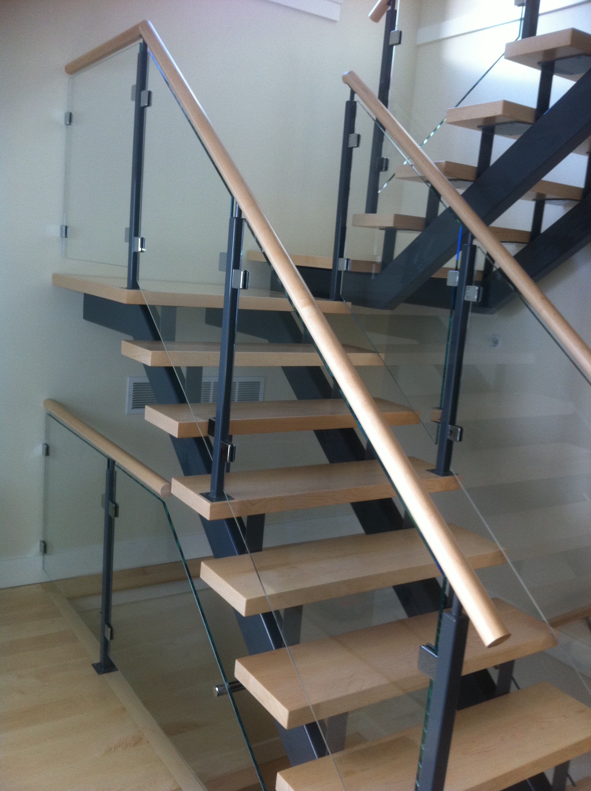 glass railing with painted posts and round wood handrail.jpg