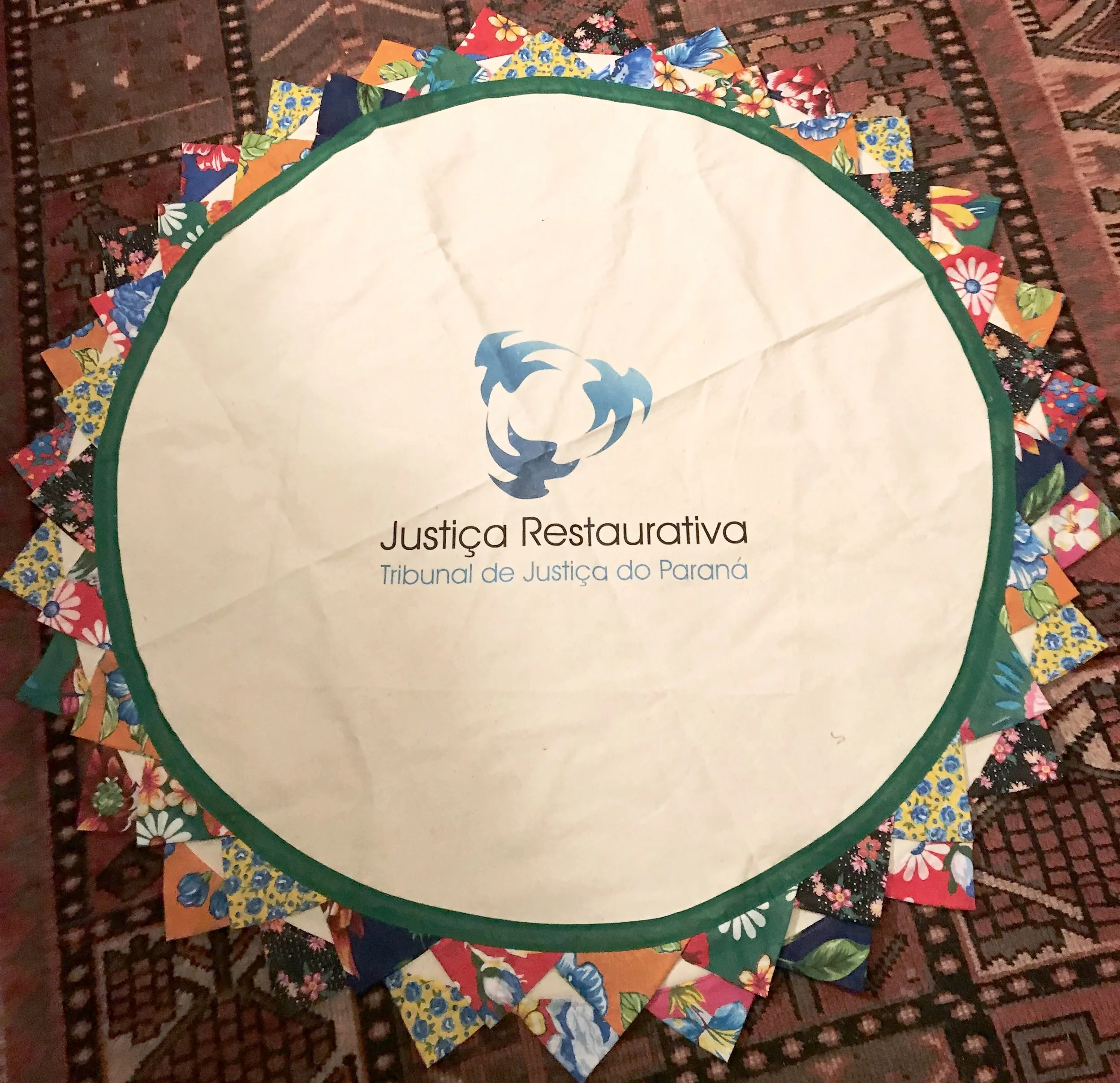 Certainly, a highlight of the morning was a beautiful gift from Jurema Carolina Gomez, representing Tribunal de Justica Restaurative. The handcrafted circle cloth includes their signature, a design depicting restorative justice in the center.