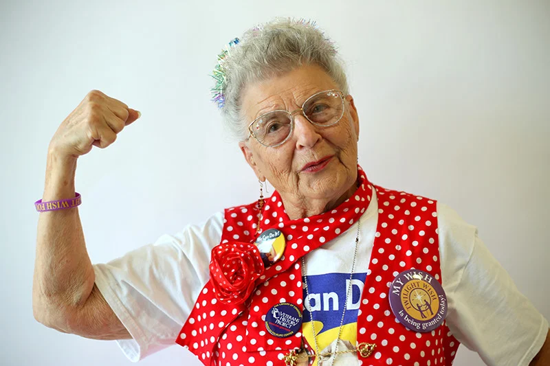 Mae wears a dog tag given to her on the runway of an airshow in Reading, Pa., where she was admiring B-17s and B-29s like the ones she built in the 1940s