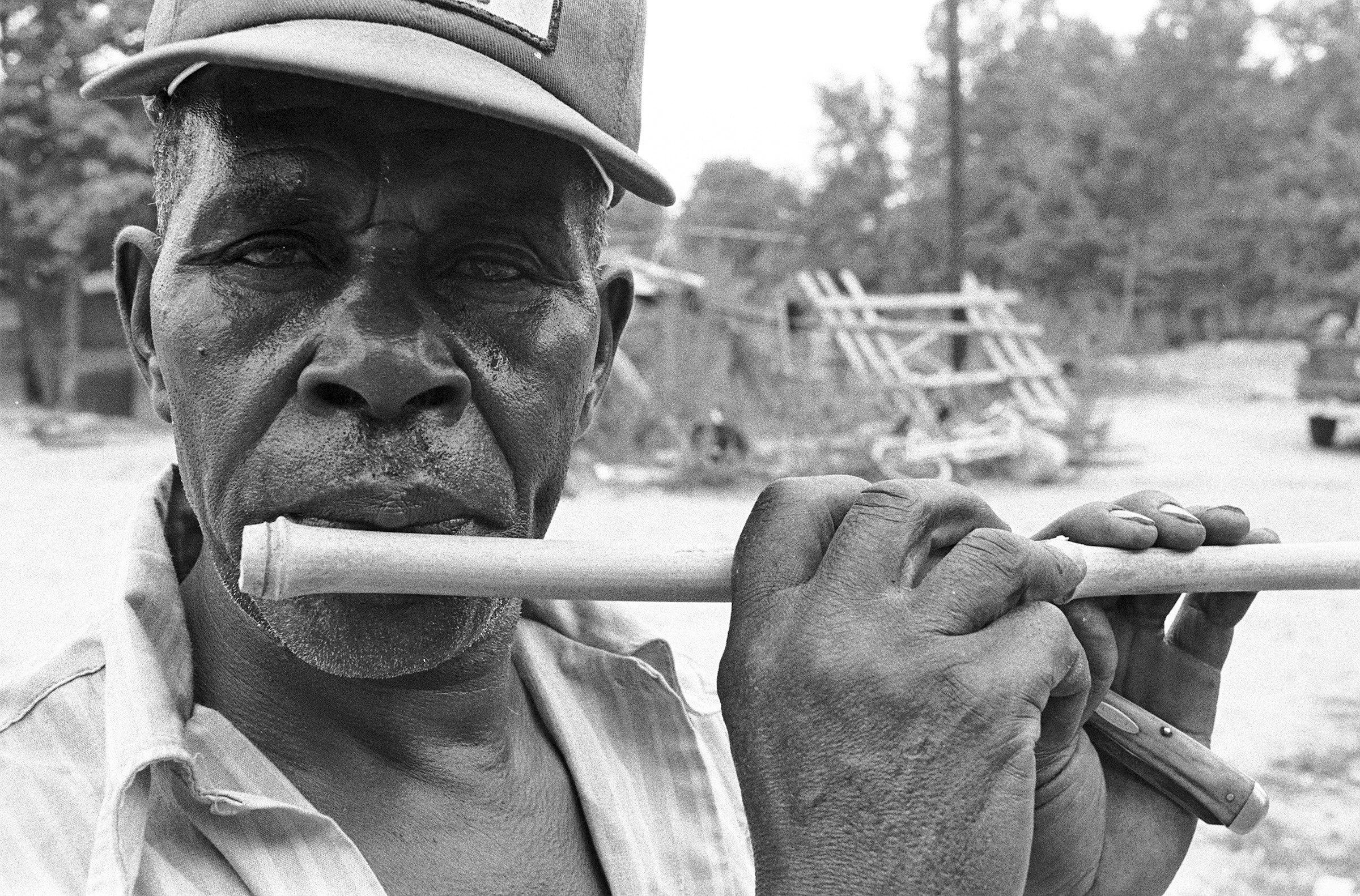 Otha Turner turns a piece of bamboo cane into a fife.jpg