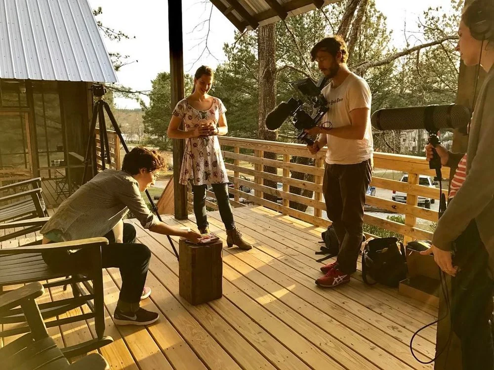 Adam Forrester films Blue Delliquanti and Chelsea Thomas on the deck of AIR Serenbe's Rural Studio cottages.