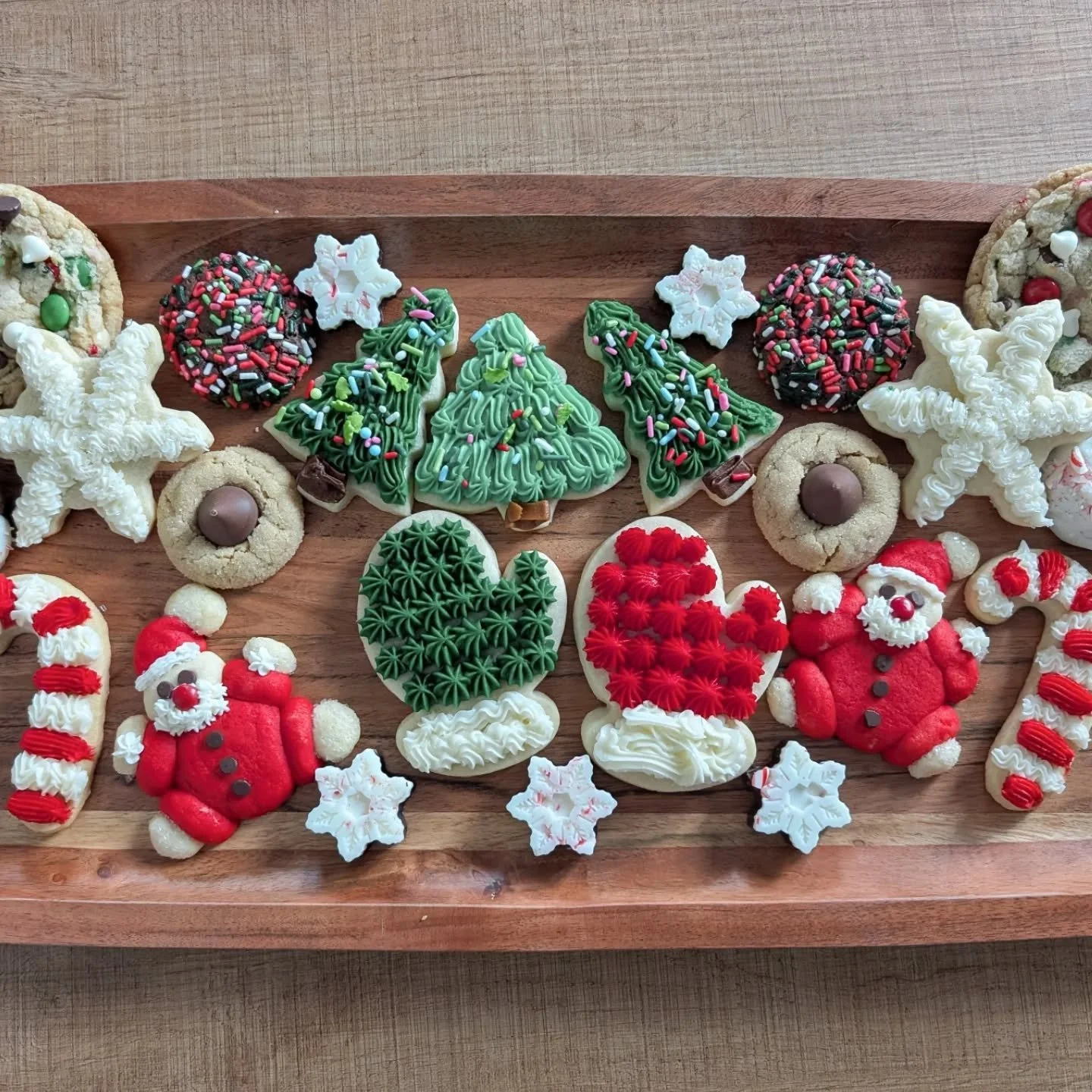 A small sampling of the 8 bazillion cookies I baked this month! Including my favorite sugar cookie recipe!

Santa cookies: @halfbakedharvest 
Peanut Blossoms, Peppermint Mocha &amp; buttercream frosting: @sallysbakeblog 
Christmas Sink: @mymessykitch