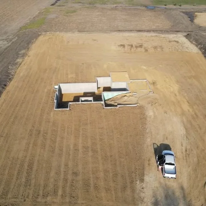 Here's the current house situation (plus a little more dirt to finish filling in the garage.)

The area around the house was backfilled and the yard was leveled out. (It still needs more work later.) My kids were devastated their mountains were destr