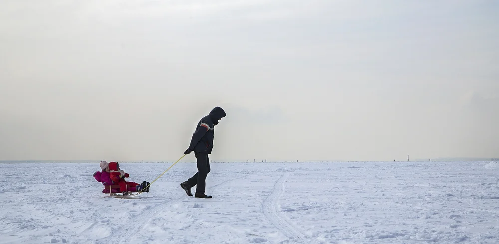 MONTREAL, QC. FEBRUARY 11, 2014 -- A father pulls his two daughters on a sled over the frozen surface of Lac Saint-Louis on a frigid Sunday afternoon in Lachine. (Leslie Schachter/Unpublished)