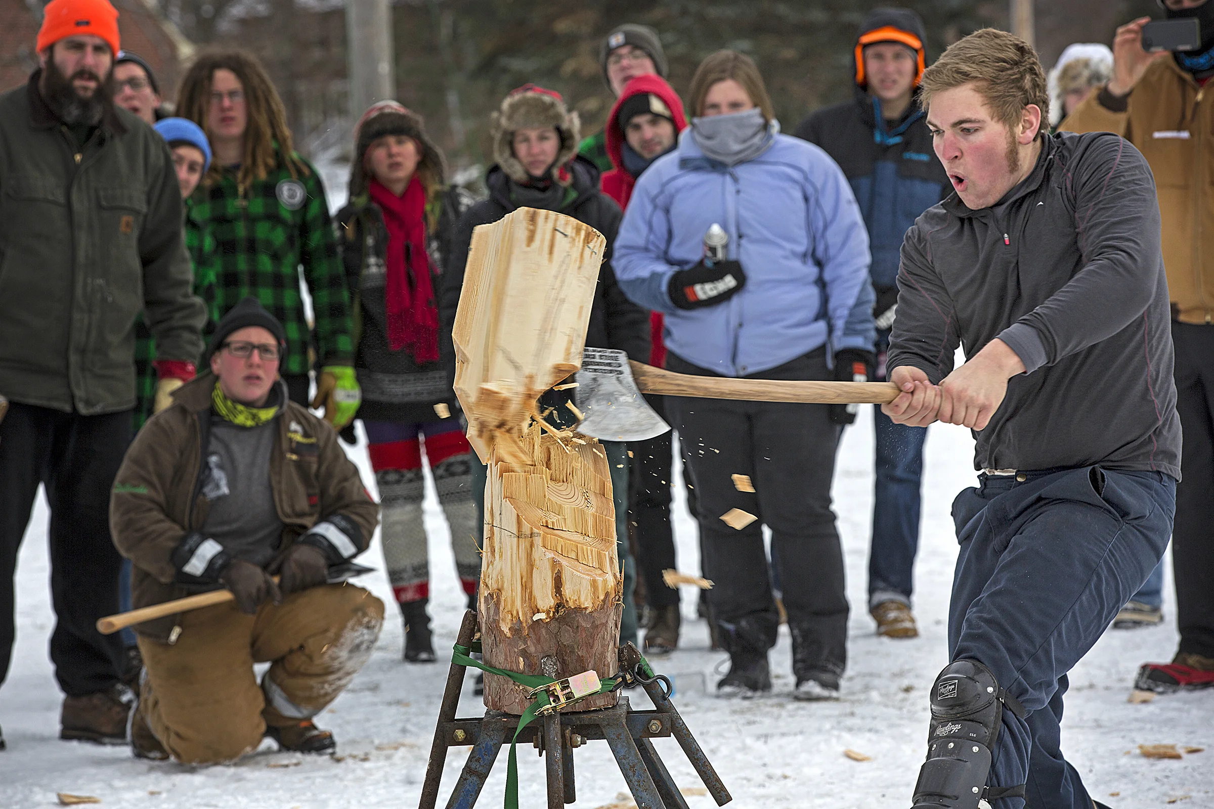 MONTREAL, QC. JANUARY 25, 2014 -- A participant chops through a log at the 54th Annual Macdonald Woodsmen Competition at McGill University’s Macdonald Campus in Sainte Anne de Bellevue on the West Island of Montreal on January 25, 2014. (Leslie Schachter/McGill Reporter)