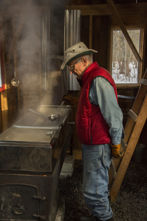 VANKLEEK HILL, ON. APRIL 1, 2013 -- Retiree and hobby farmer Cameron Rodger brings a few logs into his sugar shack at his farm in Vankleek Hill, ON, on Monday, April 1, 2013. The image is part of a photo essay about Rodger, who recently lost his wife to cancer, as he goes about his annual maple syrup production for the first time since her death in late 2012. (Leslie Schachter / Personal project)