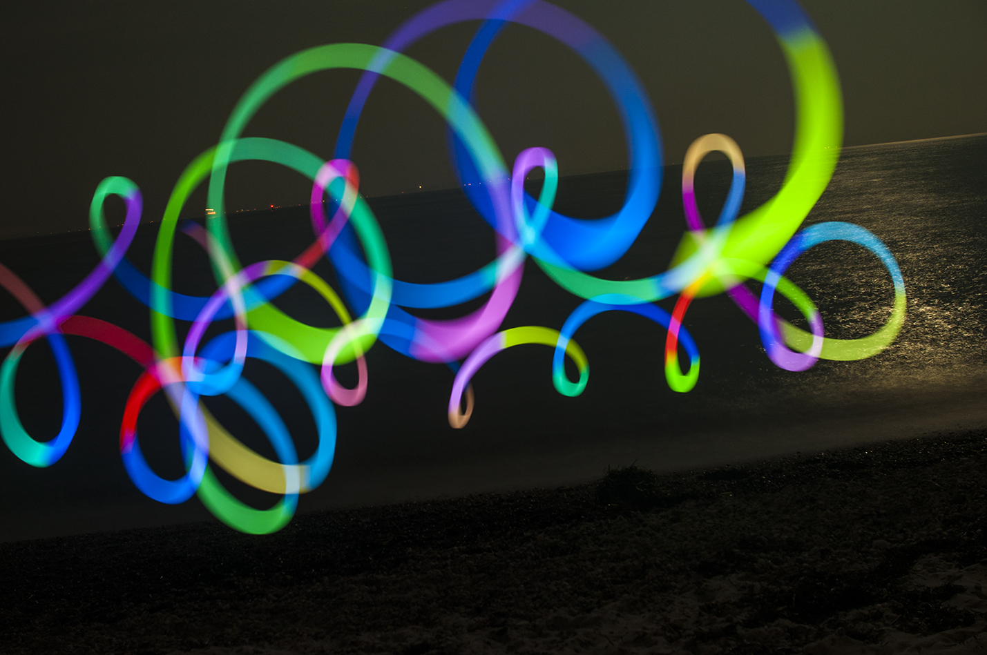 My Nikon was stable on the wall to the beach. I used the flashlight app on my iPhone set to TRIPPY which rotated colors as I created the swilling pattern. I could have stayed out there all night making these light paintings.