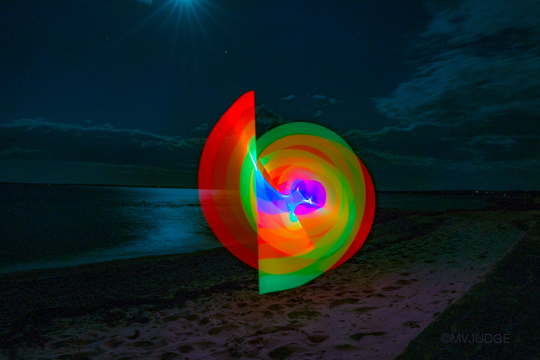 "swirl" mvjudge©2016 The "Rainbow Lights the Dark" series was created a week after the Orlando nightclub shooting. The beauty of the full moon and the Cape Cod beach reminded me as I swirled the rainbow lights, that the victims, so many young lives, will never enjoy another full moon, or a beach, or the joy of creating and sharing their vision with the world. Each time I look through these photos I'm stricken with grief, and hope that we all can wave our rainbow in unity and pride. All rights reserved @mvjudge 2016