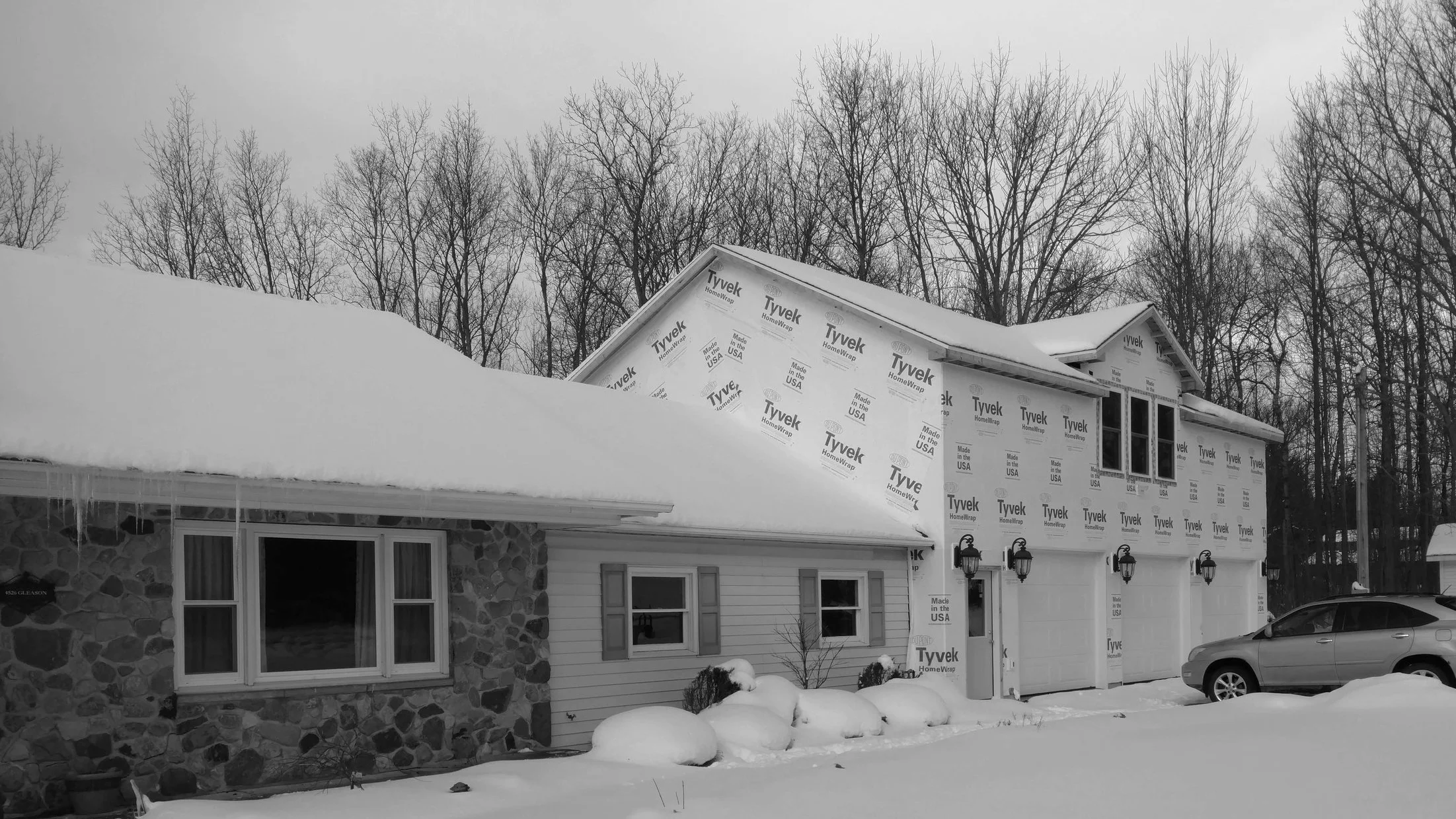 Existing garage (center) adjacent to a new garage addition (right).