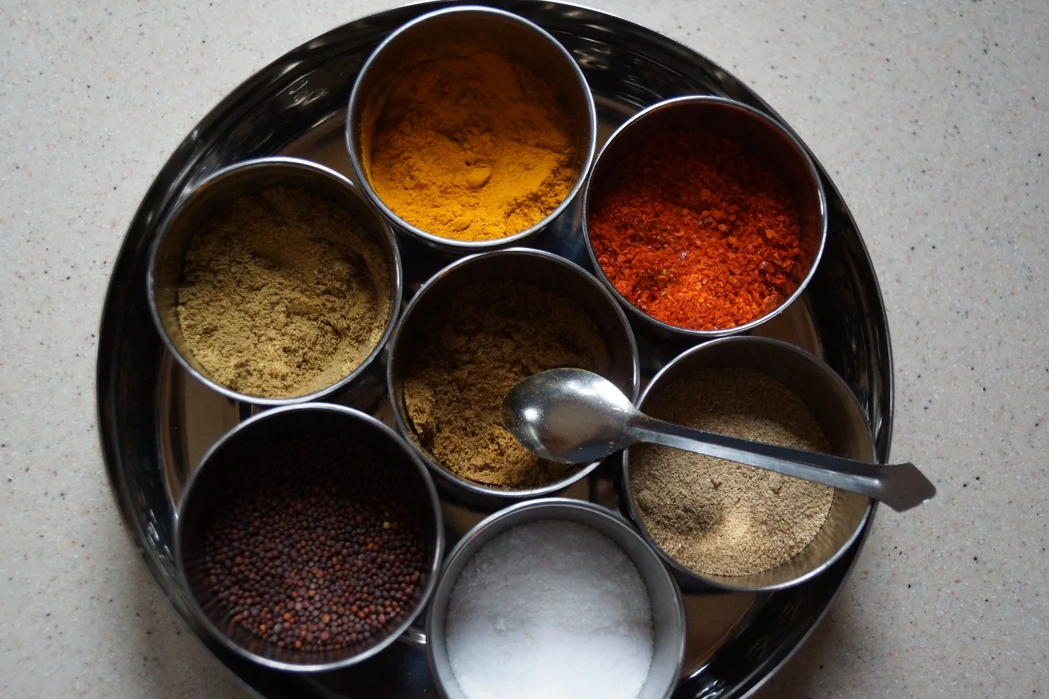 Masala Dabba of Indian Spices - Turmeric, Red Chile, Dried Mango Powder, Salt, Mustard Seed, Coriander, and Cumin