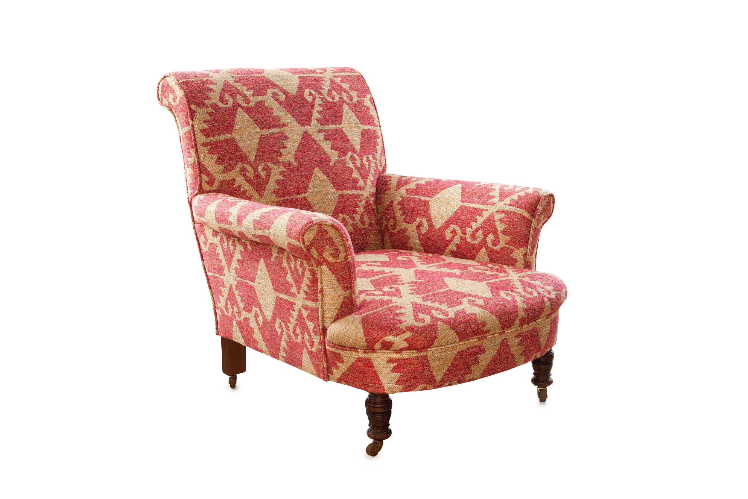 Connaught armchair with piped "cap-on" facings on arms and back, turned legs and castors