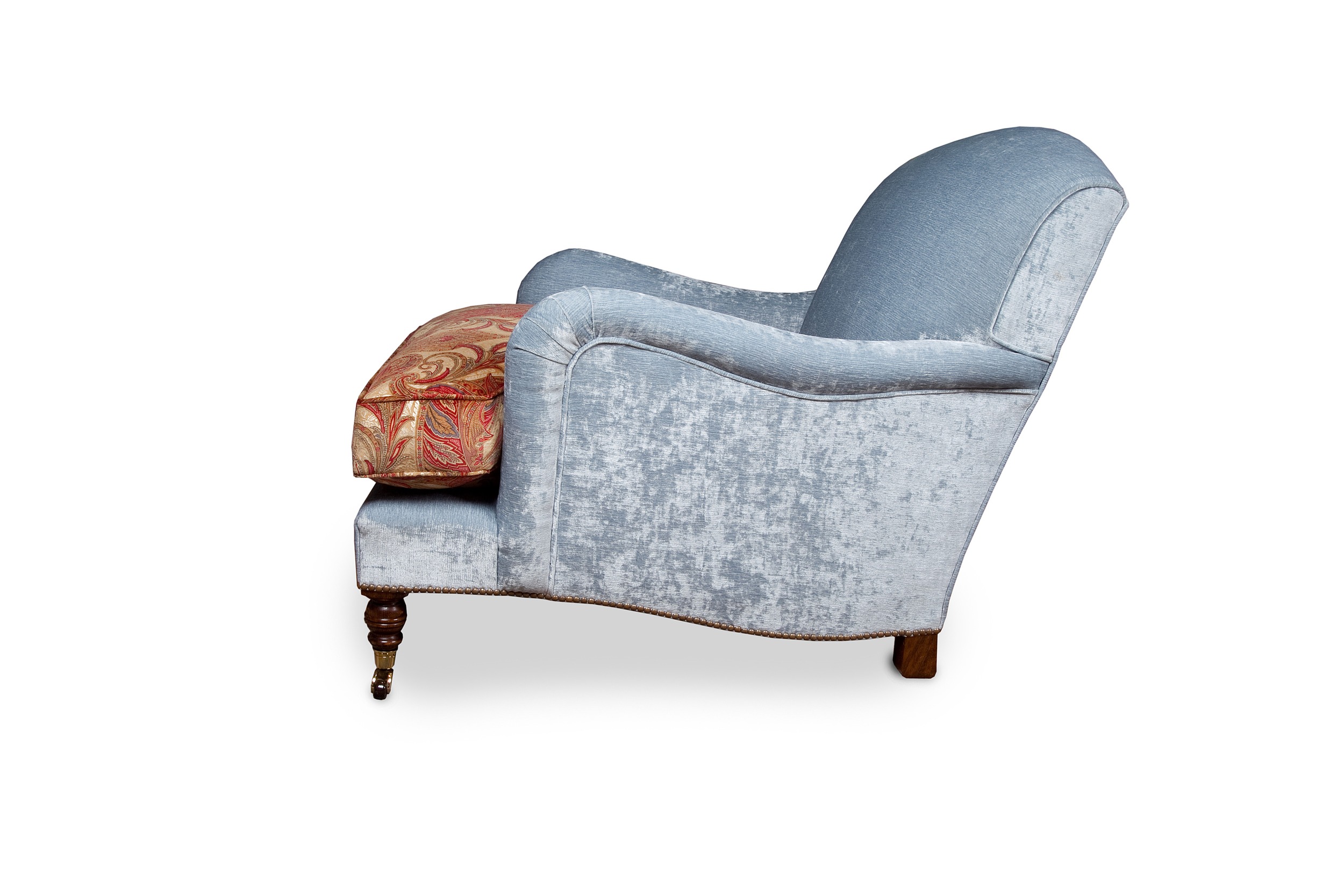 "Howard" armchair with brass and brown ceramic castors, feather down cushion and base rails trimmed with individual antique brass nail heads