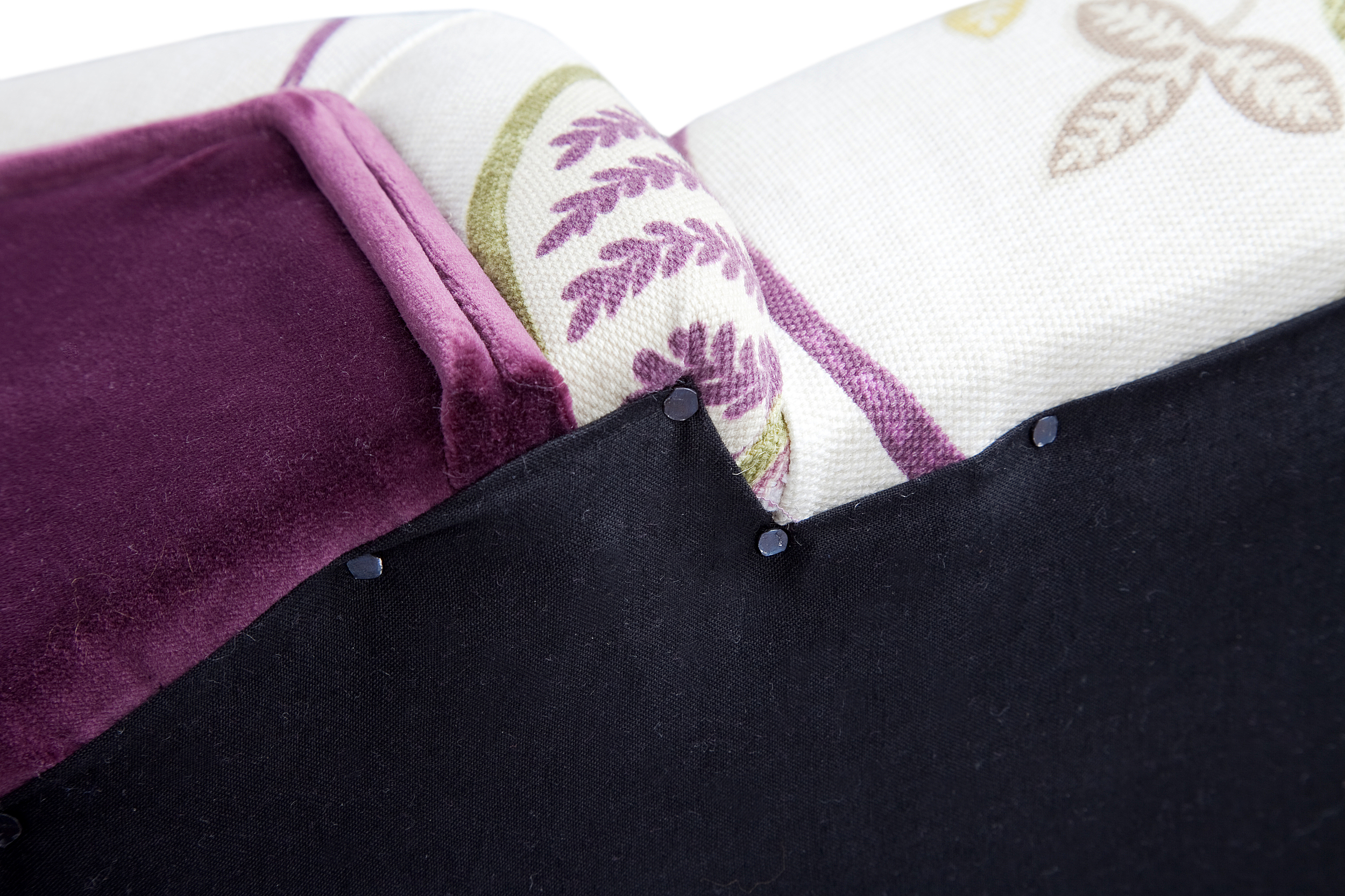 Black cotton bottoming cloth is secured with traditional fine tacks to the underside of all pieces