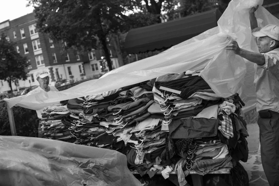 Residents who stay in Love Mission House as a temporary shelter in Flushing, Queens, wrap up to close the charity bazaar for the day. August 6th, 2013. Currently the landlord banned the bazaar due to complaints from other neighbors.