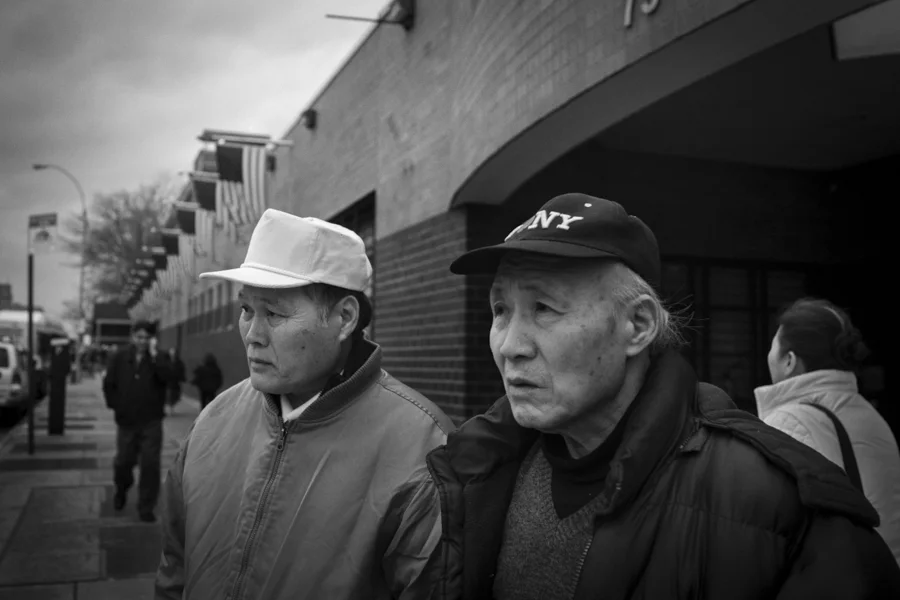 Moses Chon, left, with Mr. Lee who had treatment in the Elmhurst Hospital waits to cross the street, April 4th, 2014.