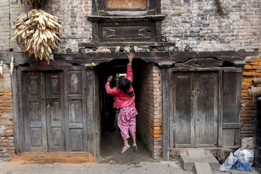 A youth jumping to reach the ceiling in the streets of Bungamati, Kathmandu Valley, Nepal, November 16th, 2014. According to the Ministry of Labour and Employment, more than 520,000 labour permits were issued for foreign employment in the 2013-2014 fiscal year. Many youths also prefer to work abroad.
