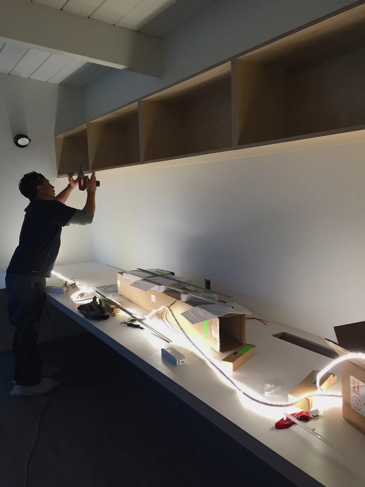 Installing high output LED strip light at upper office shelving