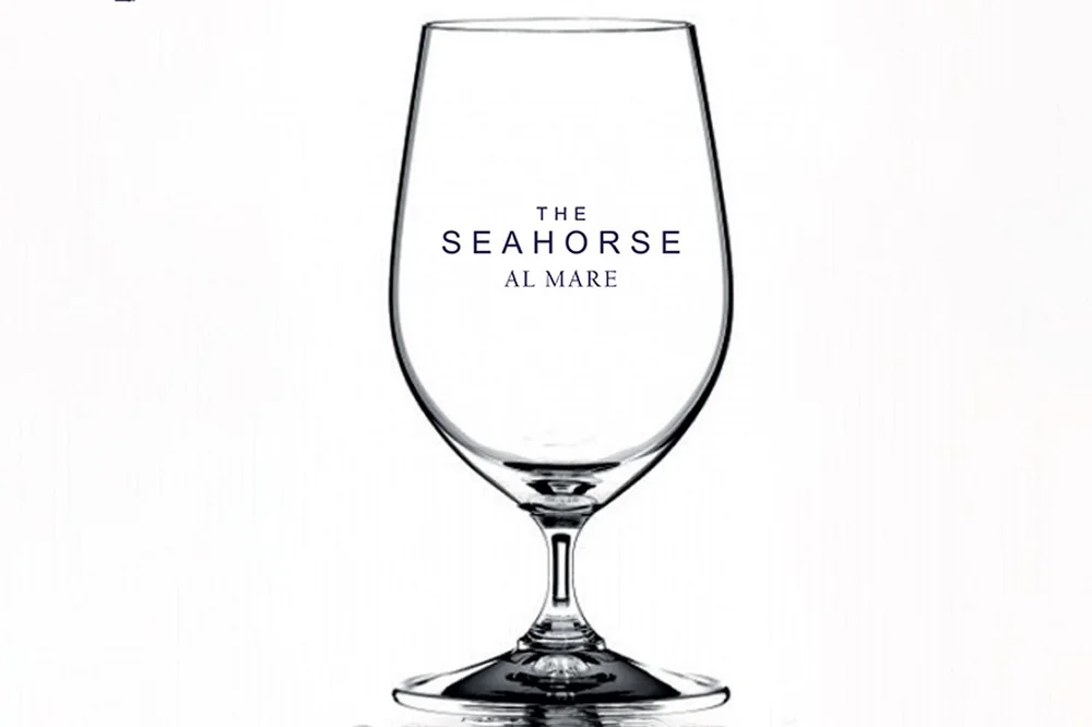 Mock-up of a wine glass printed with The Seahorse Al Mare logo