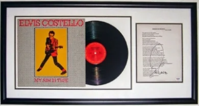 Elvis Costello Signed My Aim Is True Album & Lyric Sheet Compilation - PSA DNA COA Authenticated - Professionally Framed 34x16