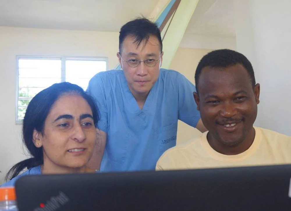 Uzma Alam (left), Michael Seo, and Pierre Evens Jean-Louis review health data at Klink Fonfrèd , Haiti