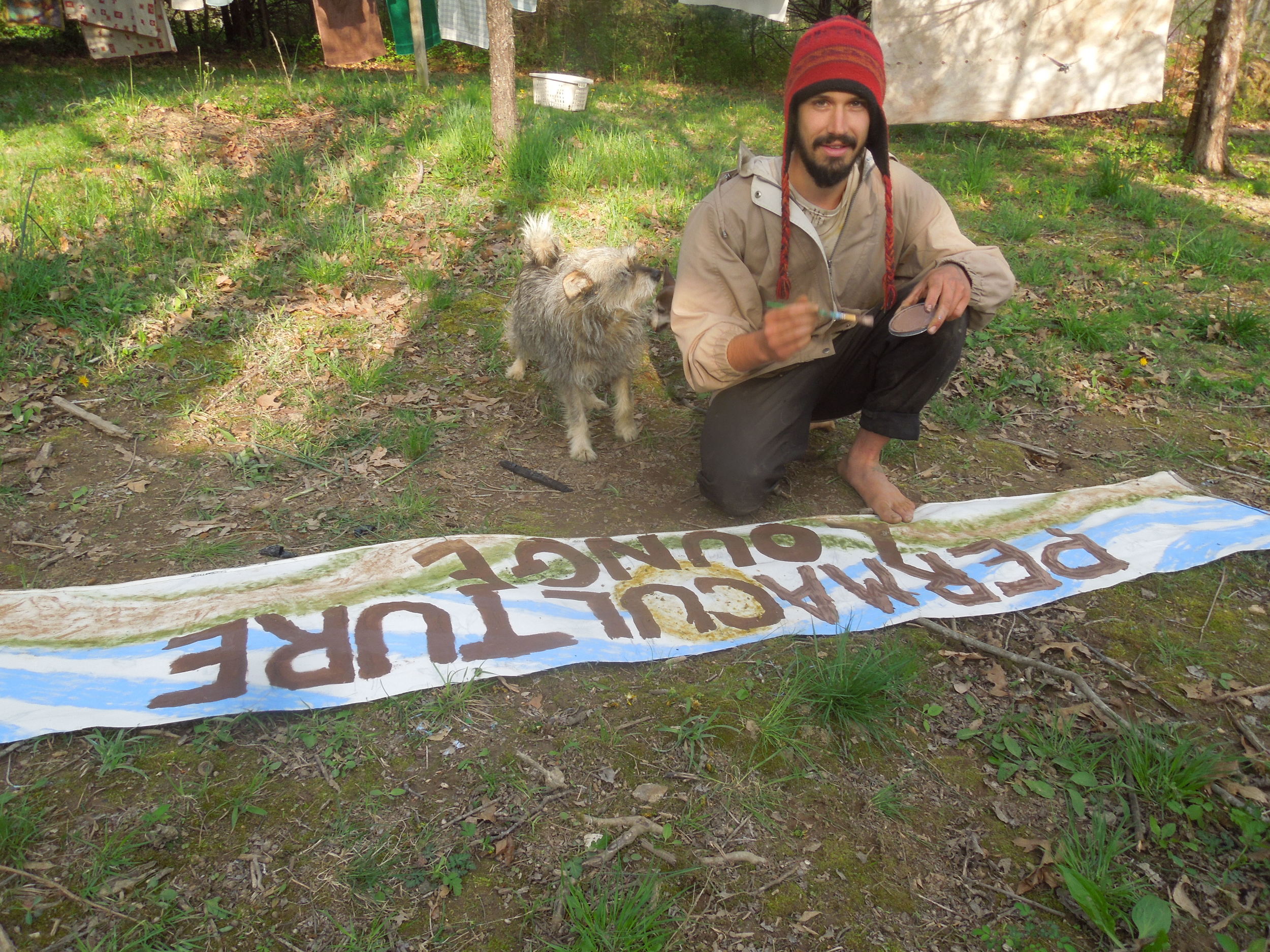 Our volunteer Ando making the sign for the Permaculture Lounge. He still has a lot more he wants to do, but it's looking great! His assistant Lolli trying to help out. 