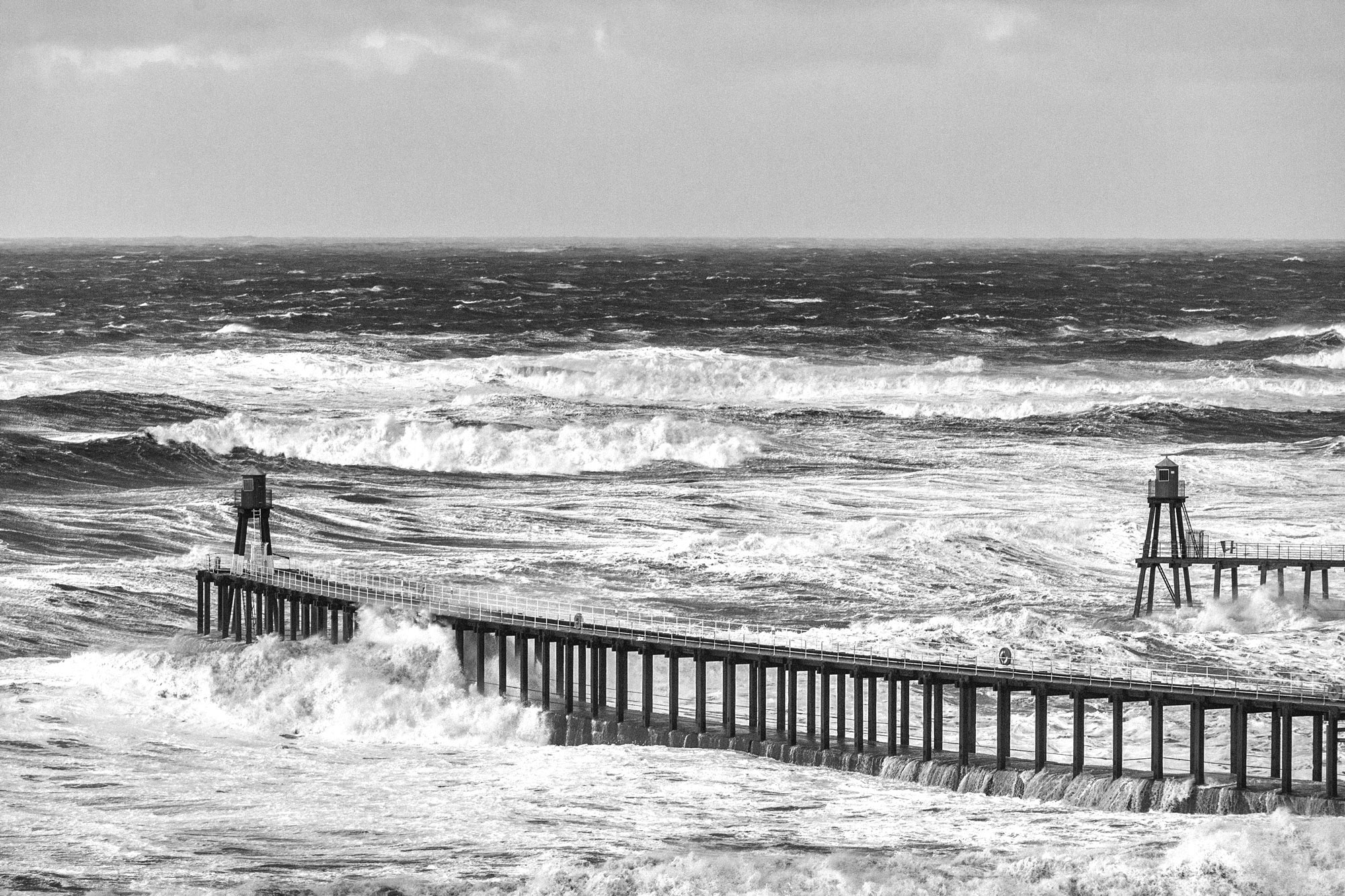 The large swell with a period of 14 seconds, batters Whitby Piers.