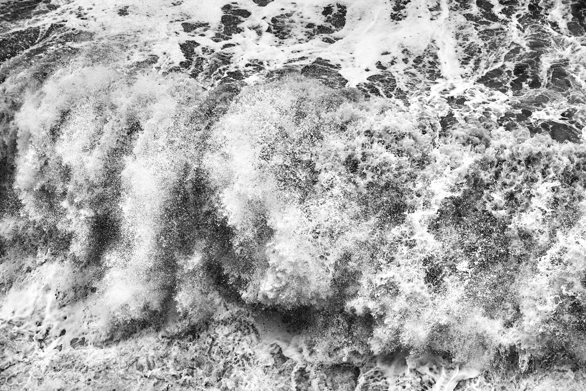 Mesmerising waves crash against the Seawall.