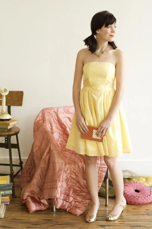 ECLAIR - Colette Strapless summer or party dress has a flattering shape which tapers at the waist, and gathered waist ties in a contrasting fabric. This dress is fully lined and has a gathered six-gore skirt with the front panel of the skirt left ungathered for a smooth line. Dress includes side seam pockets and optional boning. Closes with an invisible side zipper. 