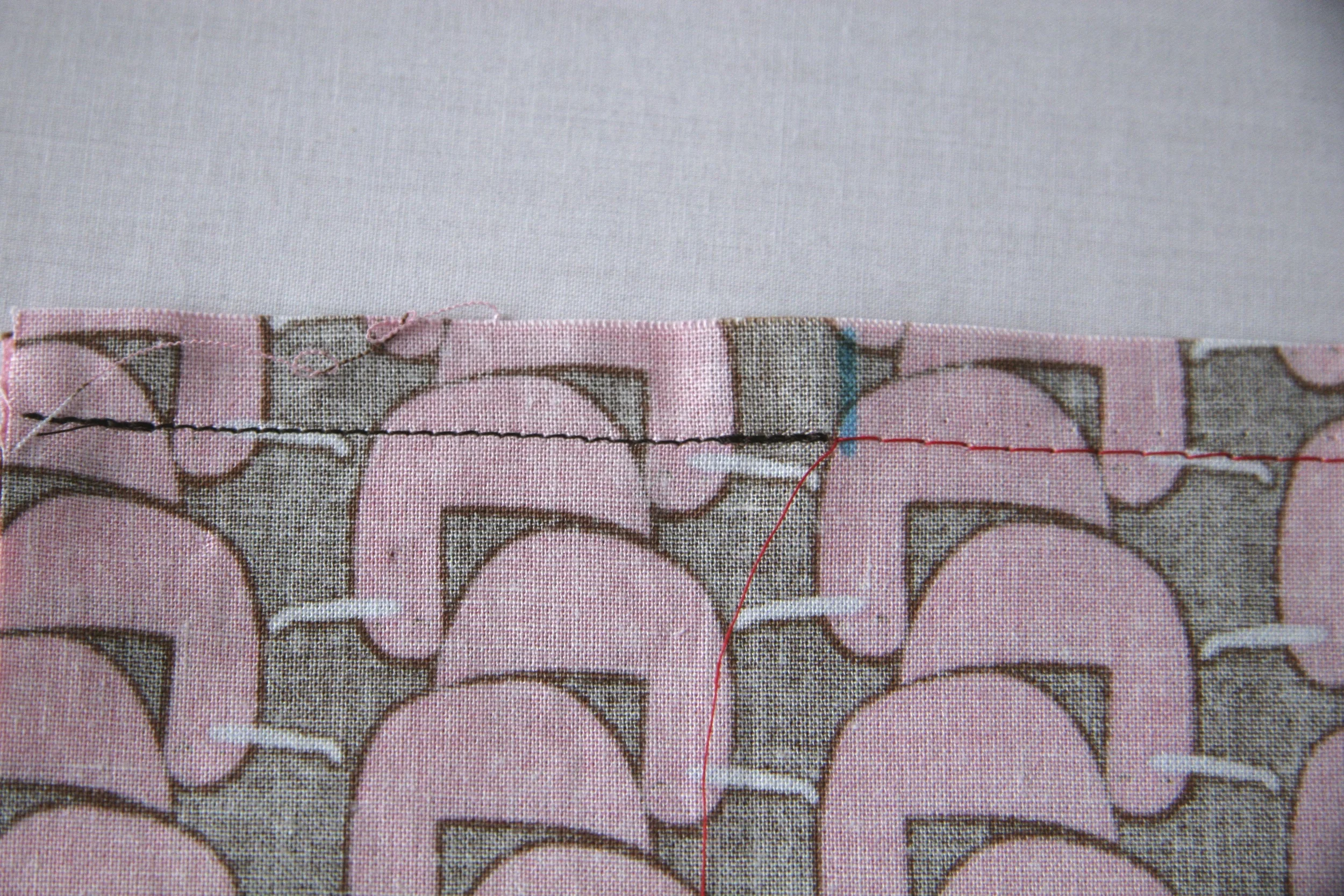 STEP 2 - Normal 1/2 inch seam in black thread with backstitch, stopping at the blue mark. And basted 1/2 inch seam in red.