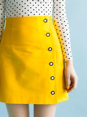 ARIELLE Tilly & The Buttons Arielle is an asymmetric pencil or mini skirt with an adorable button opening to one side. Long darts and a high waistline create a flattering, figure-hugging shape. The unlined version is an ideal project for confident beginners, or take your sewing prowess up a notch by adding the optional luxury lining.
