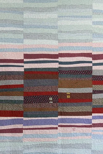 A quilt made of old shirts, ties and trousers. Image courtesy of Mamaka Mills .