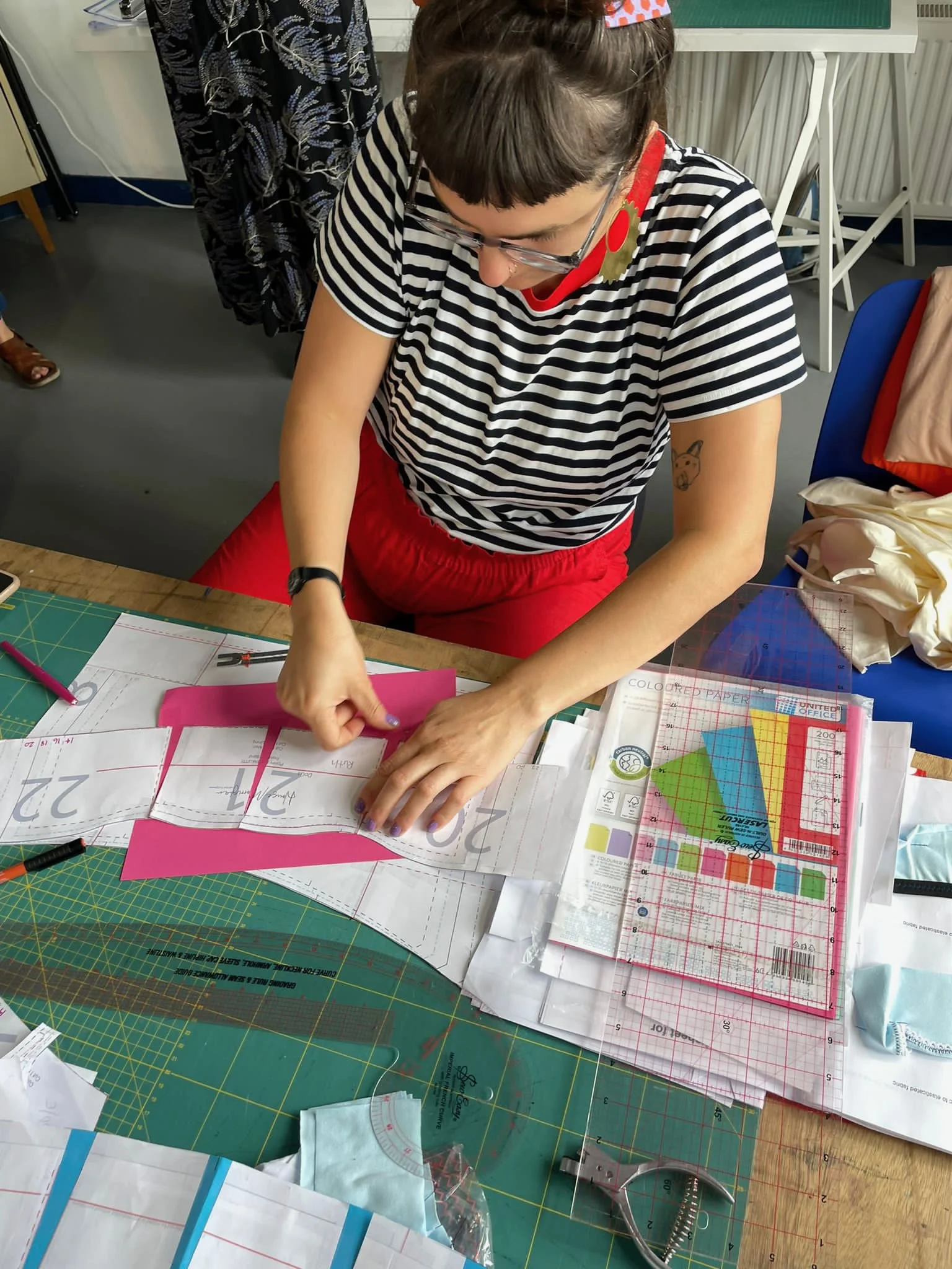 Cass piecing together a paper patter.jpeg