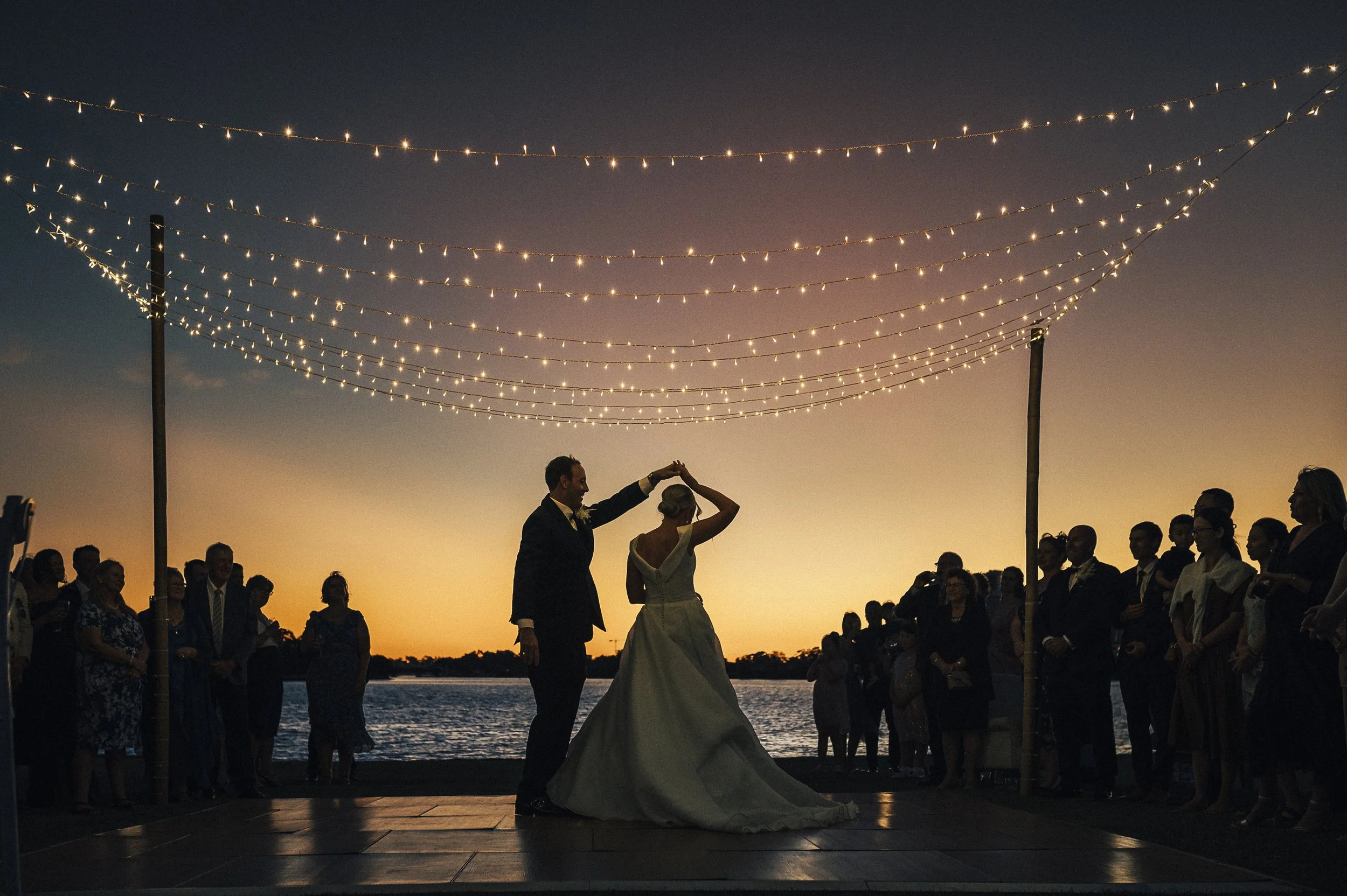 burswood-on-swan-wedding-first-dance-festoon-lights-candid.jpg