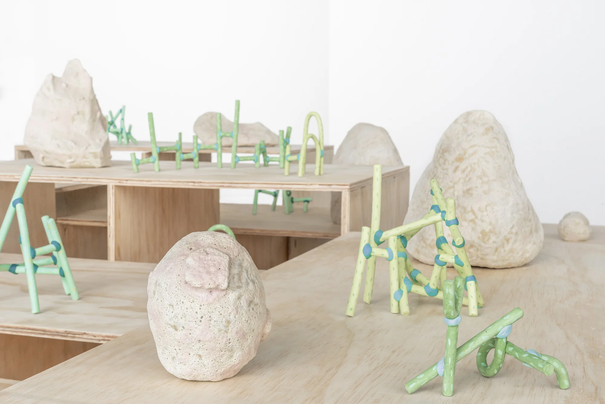   Boulders &amp; Blossoms   Glazed stoneware, earthenware, underglaze, Magic Sculp, plywood. 2018  Photo credit Third Dune Productions 