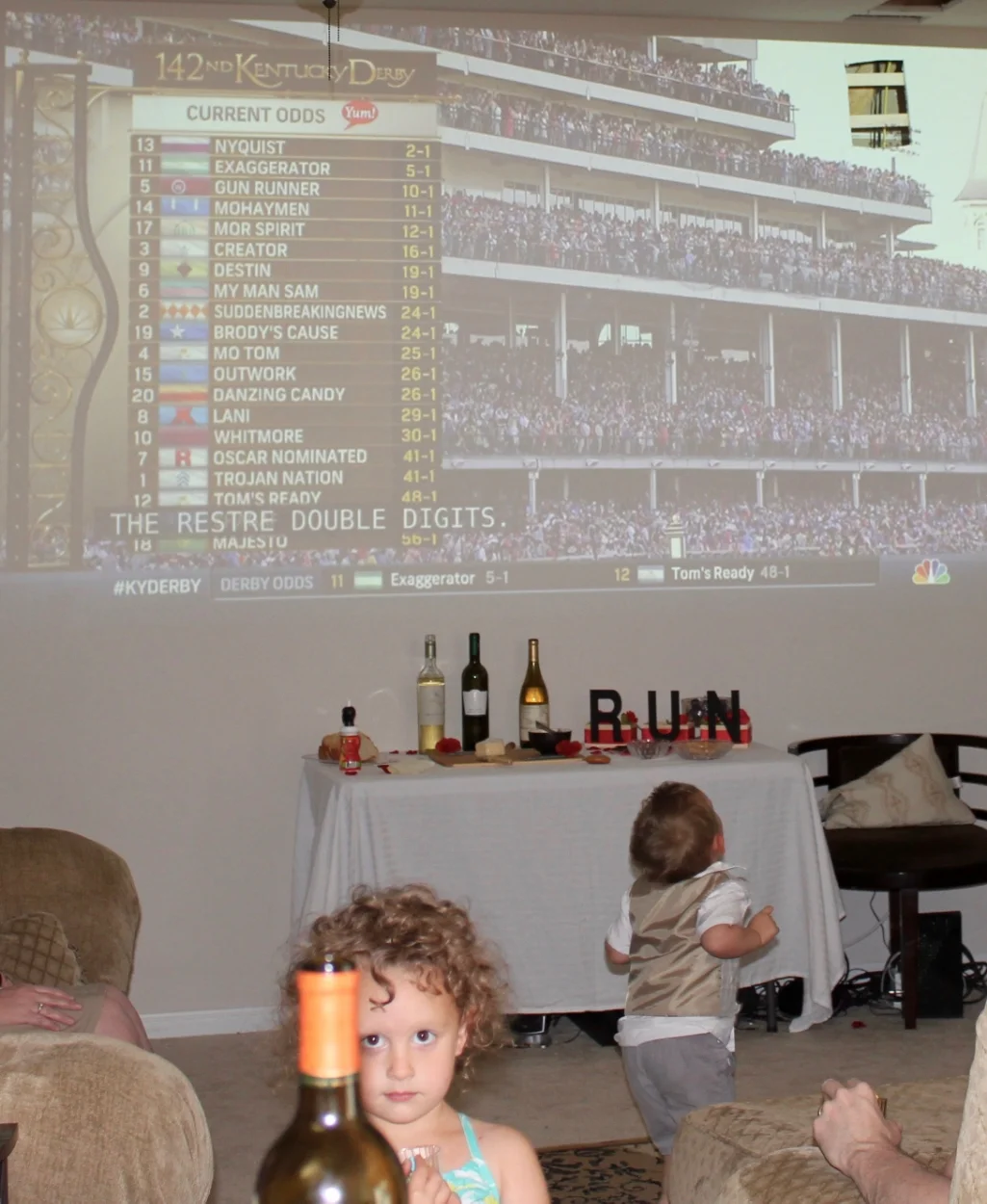 Derby line-up, a wine bottle, and toddlers. Perfect party. 