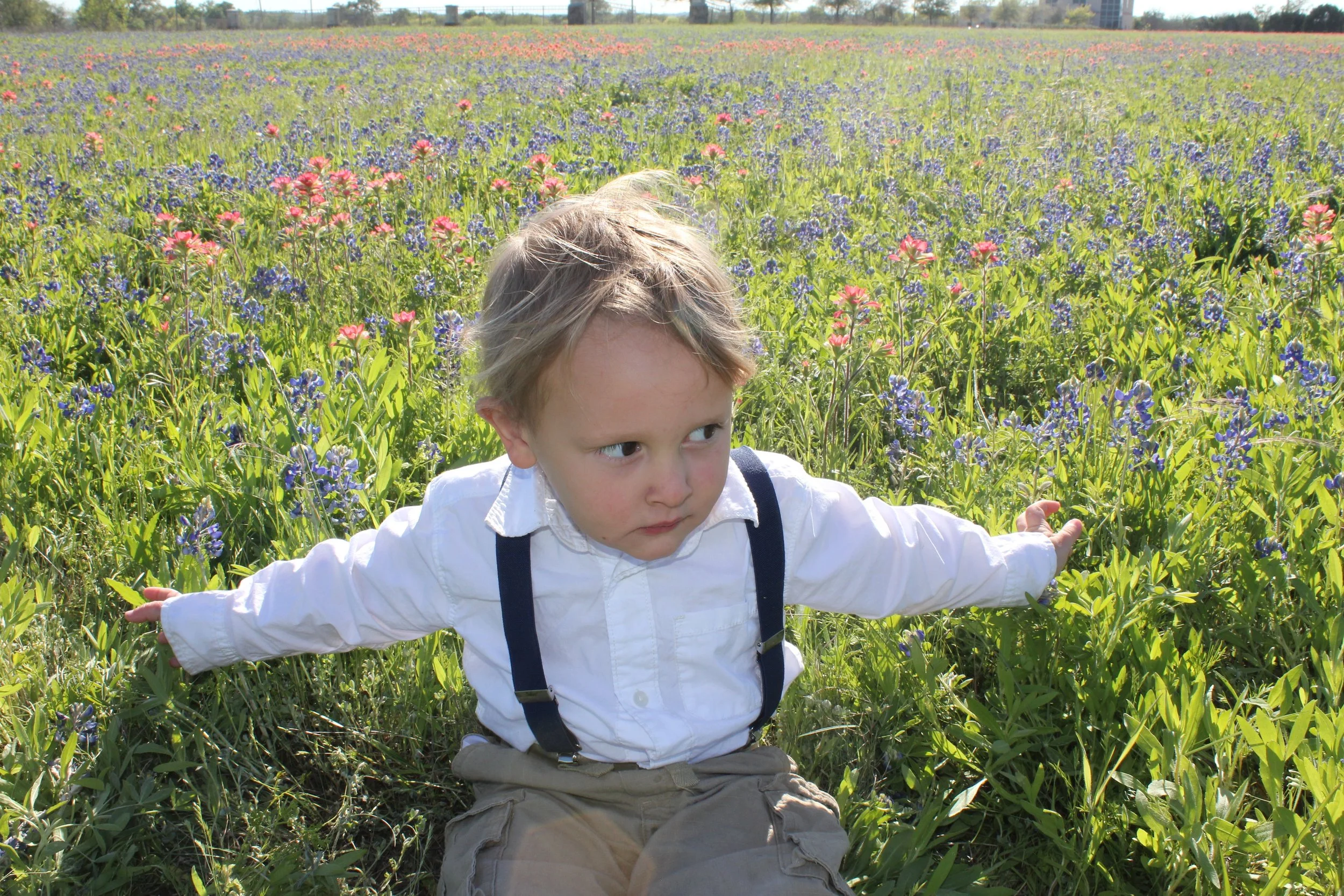Judah, lounging in a field of Bluebonnets (and Indian Paintbrushes). It's pretty much tradition to take yearly "bluebonnet pictures" here!