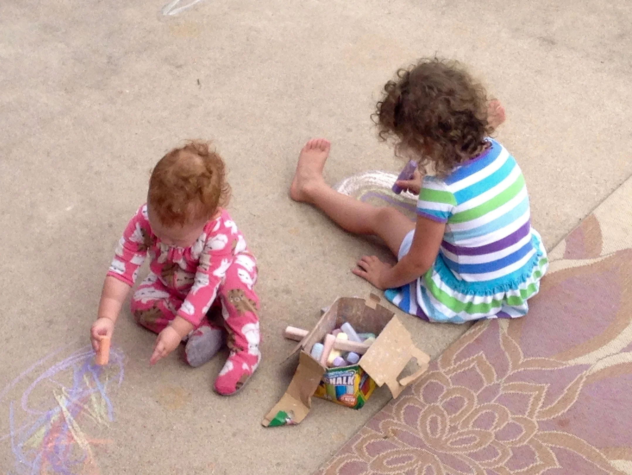 Olivia & Kenzie drawing with chalk in our backyard, practicing those fine motor skills!