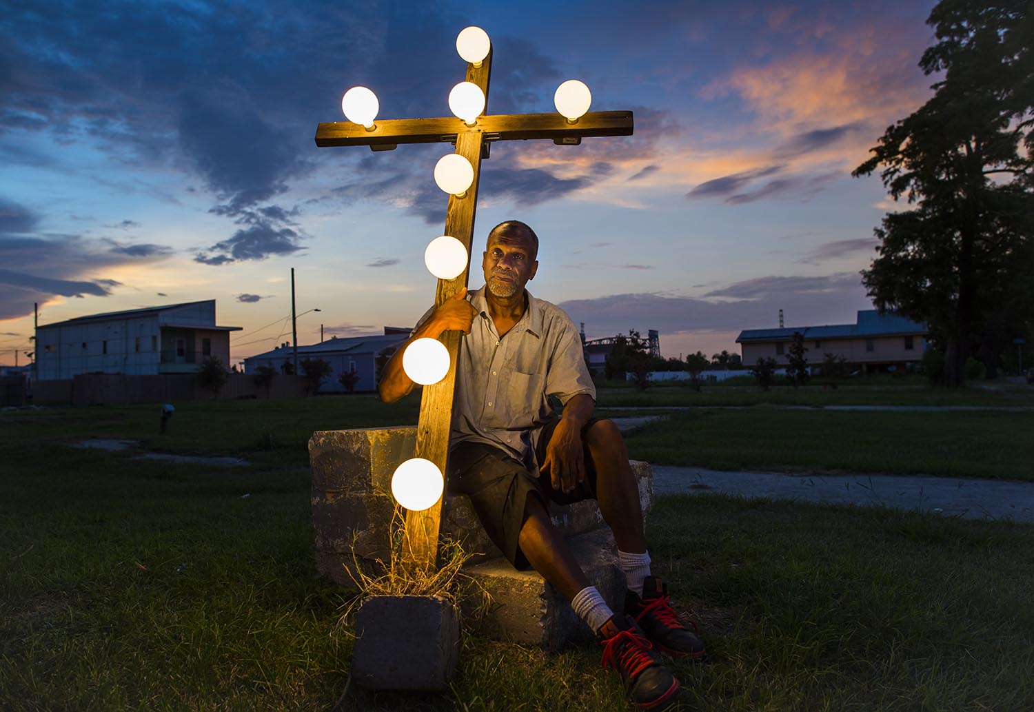 Robert Lynn Green Senior sits on the stairs of his old home July 17, 2015 which was washed away in the flooding after Hurricane Katrina. Mr. Green Lost his grandmother and granddaughter and vows to keep his cross lit until The Lower Ninth Ward is repopulated. (John Lehmann/The Globe and Mail)