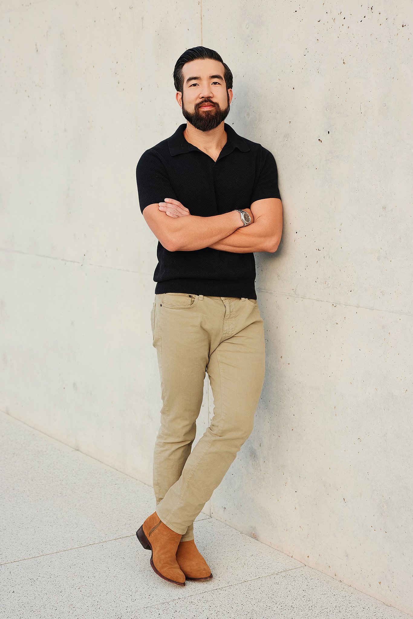 outdoor-portrait-austin-tx-man-black-polo-concrete-wall.jpg