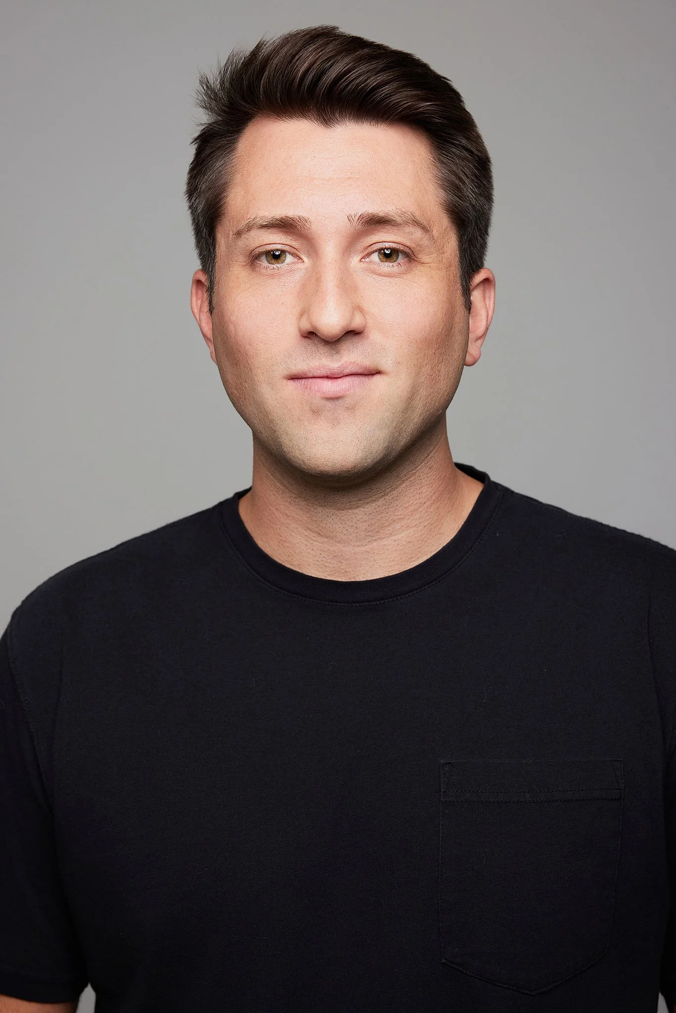 actor-headshot-austin-tx-man-black-tshirt-gray-backdrop.jpg