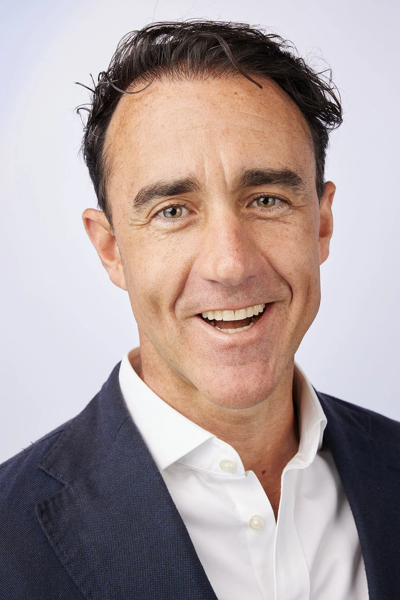 executive-headshot-austin-texas-man-navy-blazer-laughing.jpg