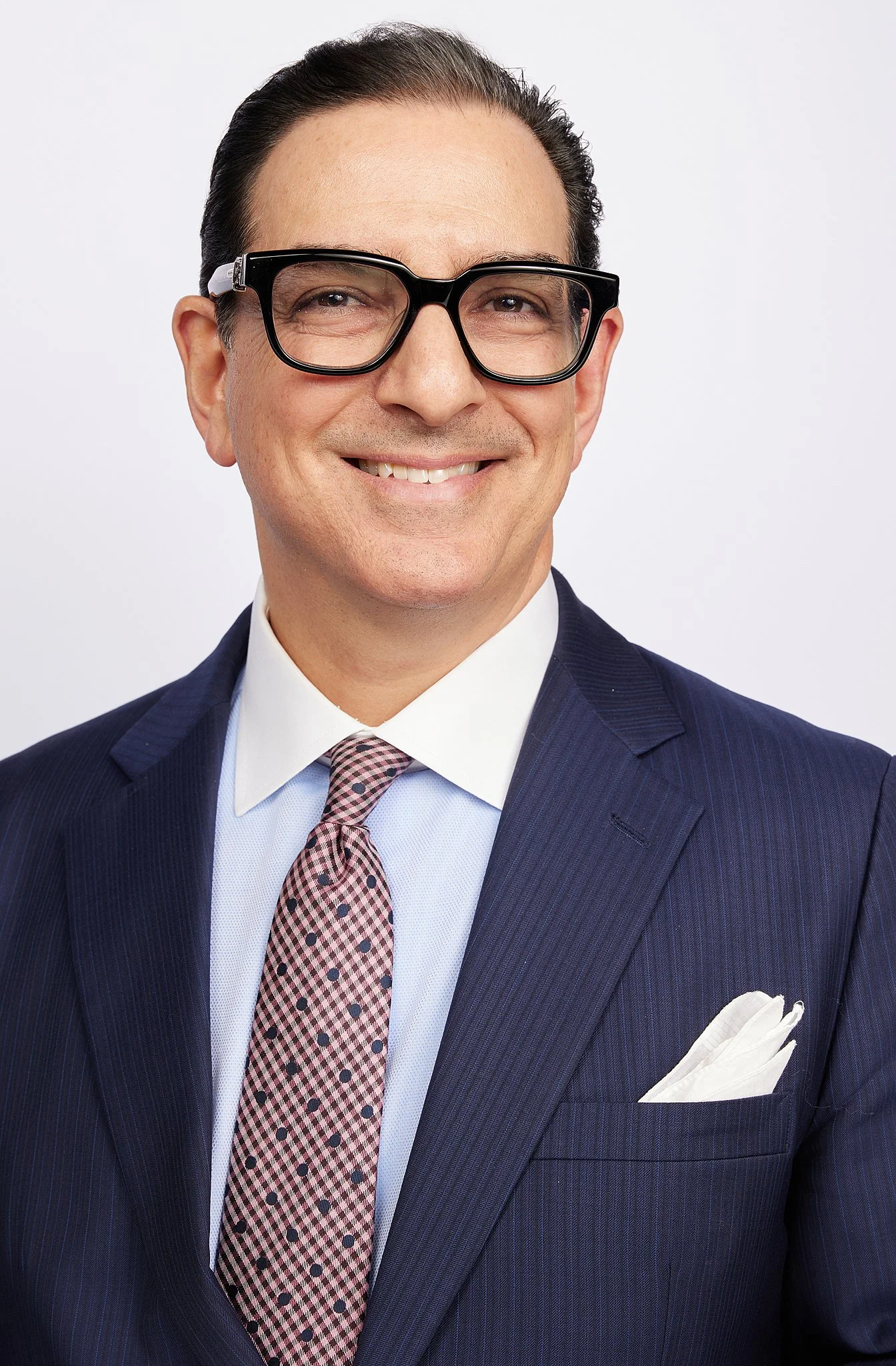 executive-headshot-austin-tx-man-pinstripe-suit-glasses.jpg