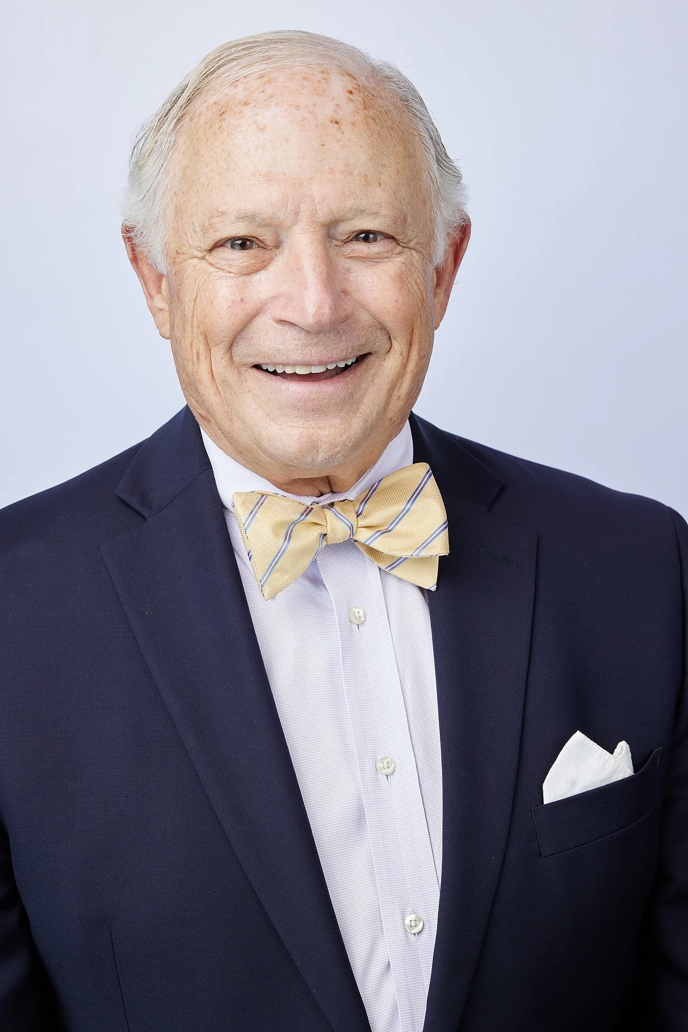 professional-headshot-austin-tx-man-navy-blazer-bow-tie.jpg