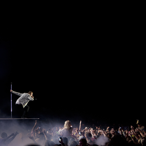 Macklemore & Ryan Lewis at stage edge of a thunderous crowd.