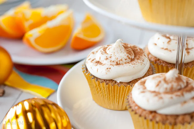 Tangy orange cream cheese frosting dusted with cinnamon